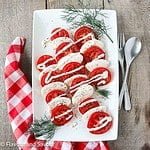 Dill Caprese Salad on a platter with fresh sprigs of dill weed.