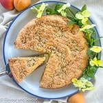 Overhead view of gluten-free almond flour apricot cake with a slice removed.