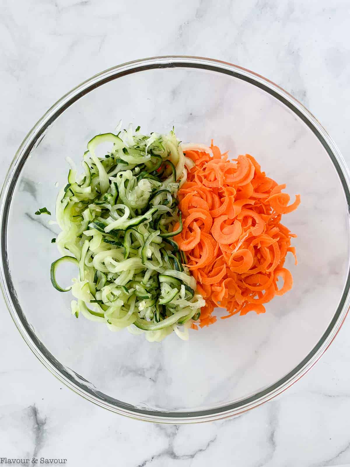 Spiralized zucchini and carrots in a bowl.