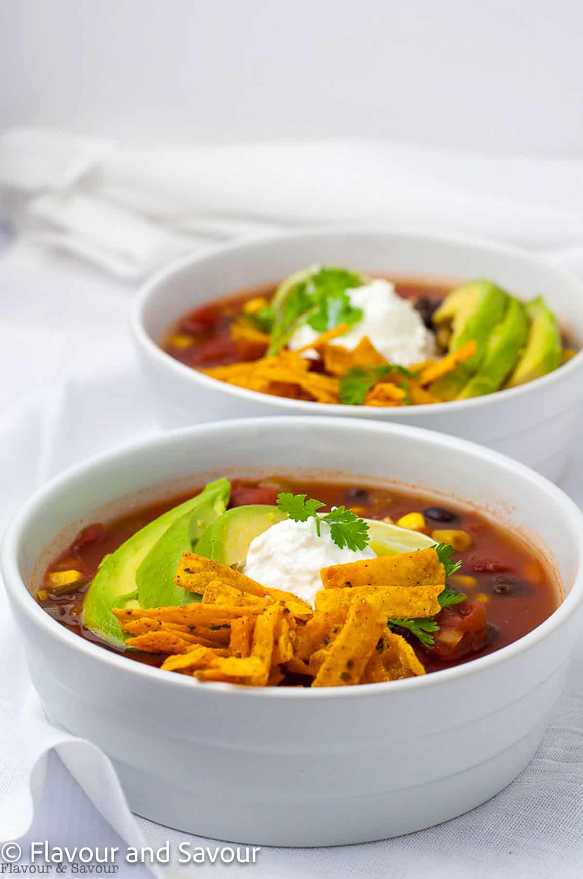 Slow Cooker Vegan Black Bean Soup in white bowls.