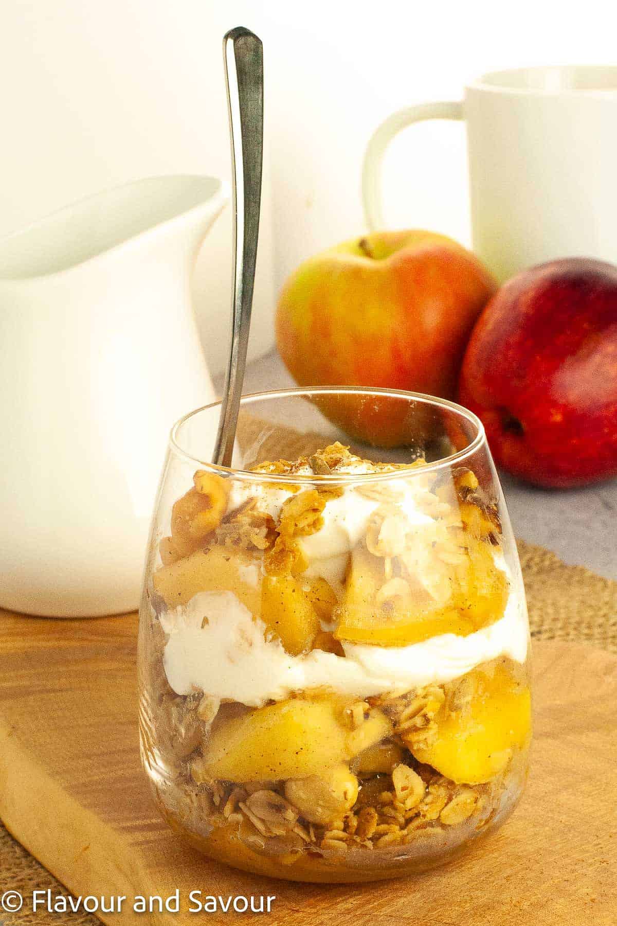 A dessert glass with gluten-free apple crumble yogurt parfait.