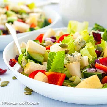 Two bowls of Asian Pear Chopped Salad with blue cheese and cranberries.