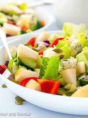 Two bowls of Asian Pear Chopped Salad with blue cheese and cranberries.