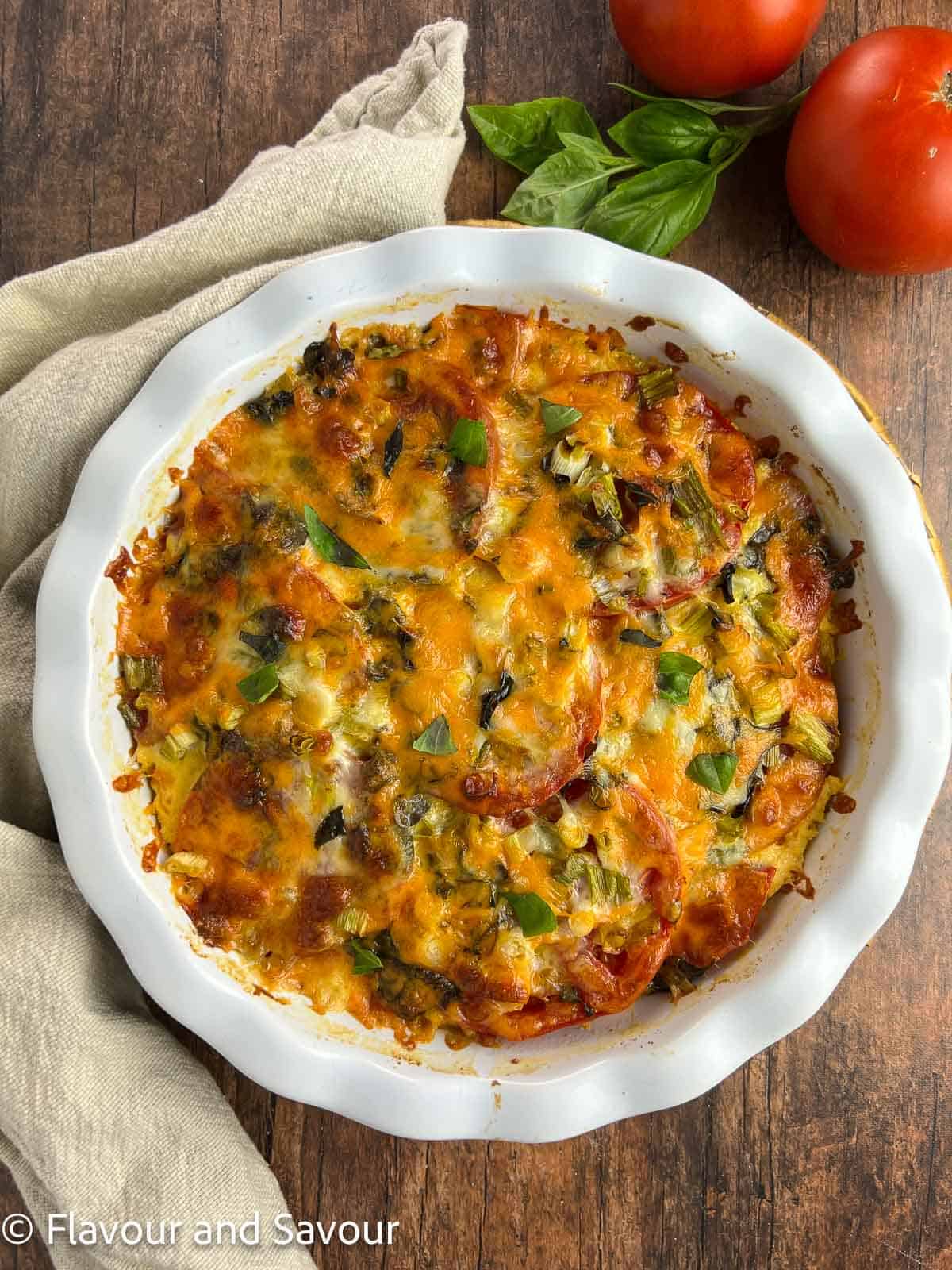 Overhead view of gluten-free tomato pie in a pie dish.