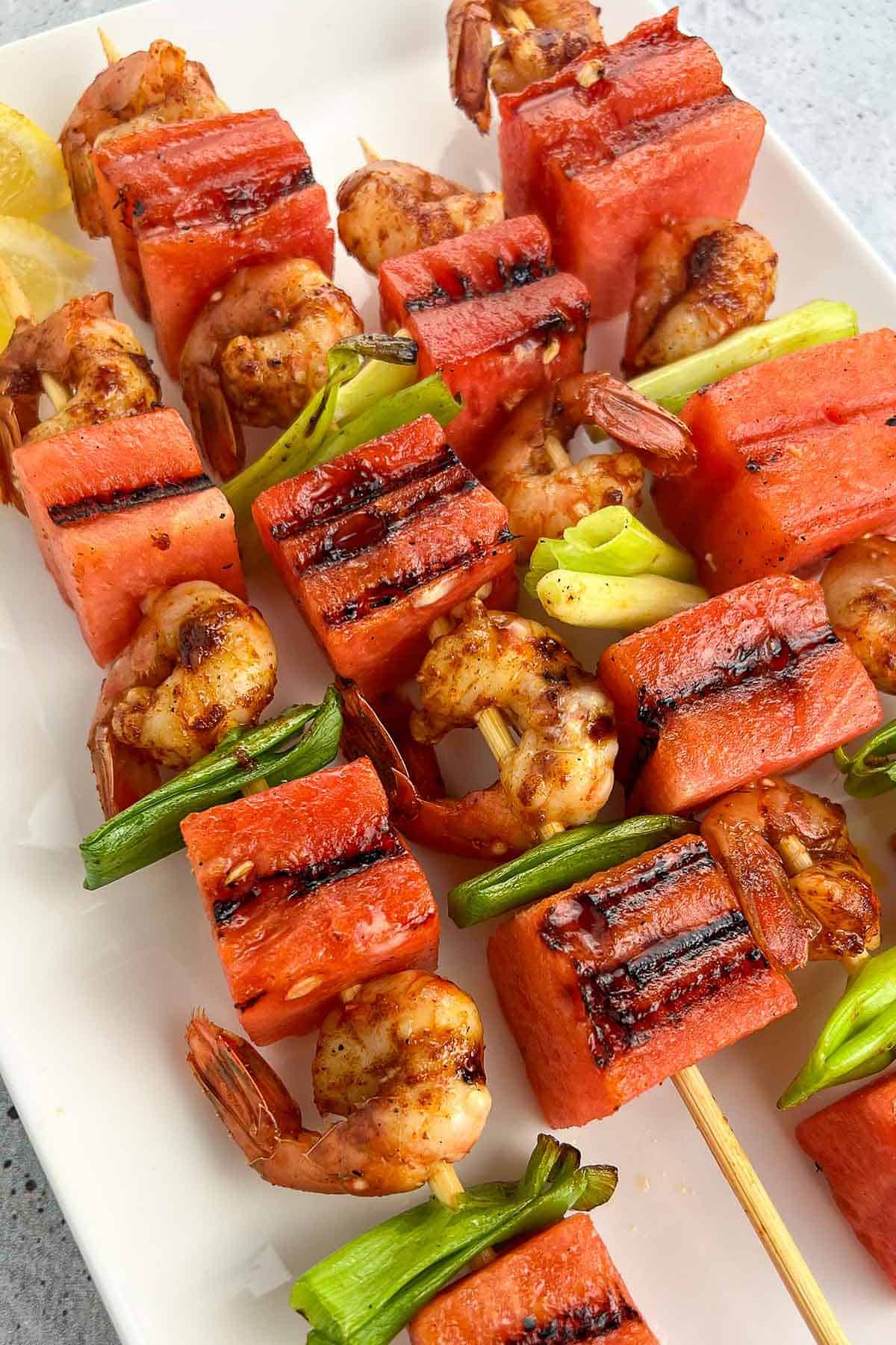 Skewers alternating watermelon chunks, green onion and spot prawns.