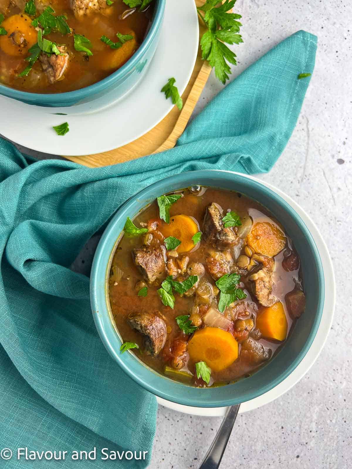 A bowl of lentil and chicken sausage stew.