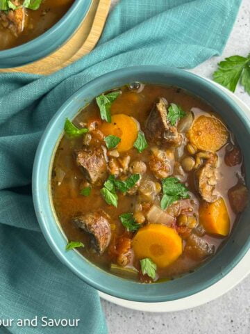 A bowl of lentil and sausage stew.