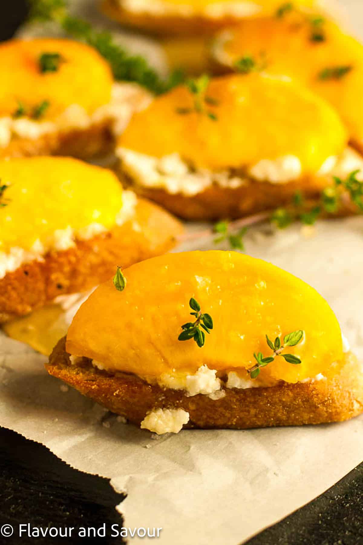 Closeup view of peach crostini with honey and lemon ricotta.