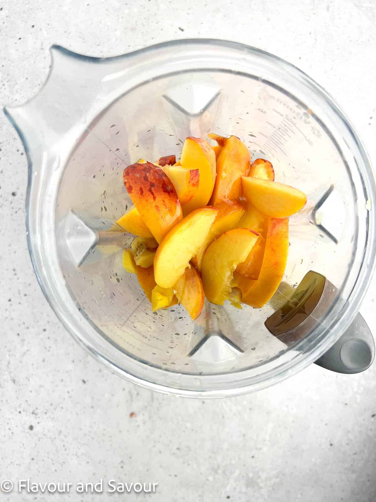 Peach slices, honey, lemon juice and ginger in a blender container.