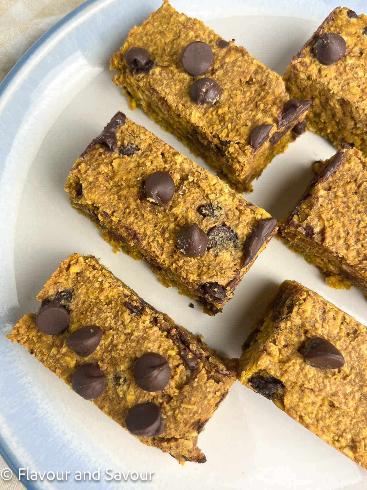 Pumpkin chocolate chip oat squares cut in half to make bars.