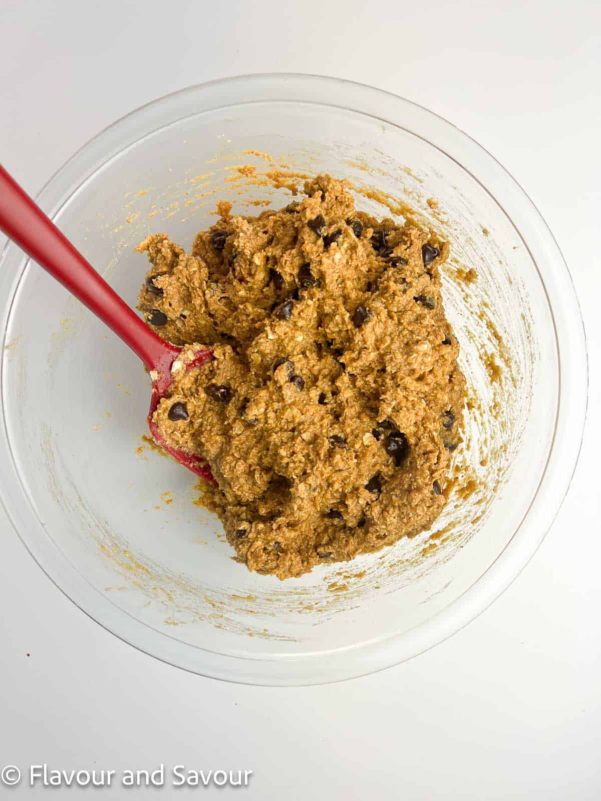 Chocolate chips stirred into pumpkin oat bar batter.