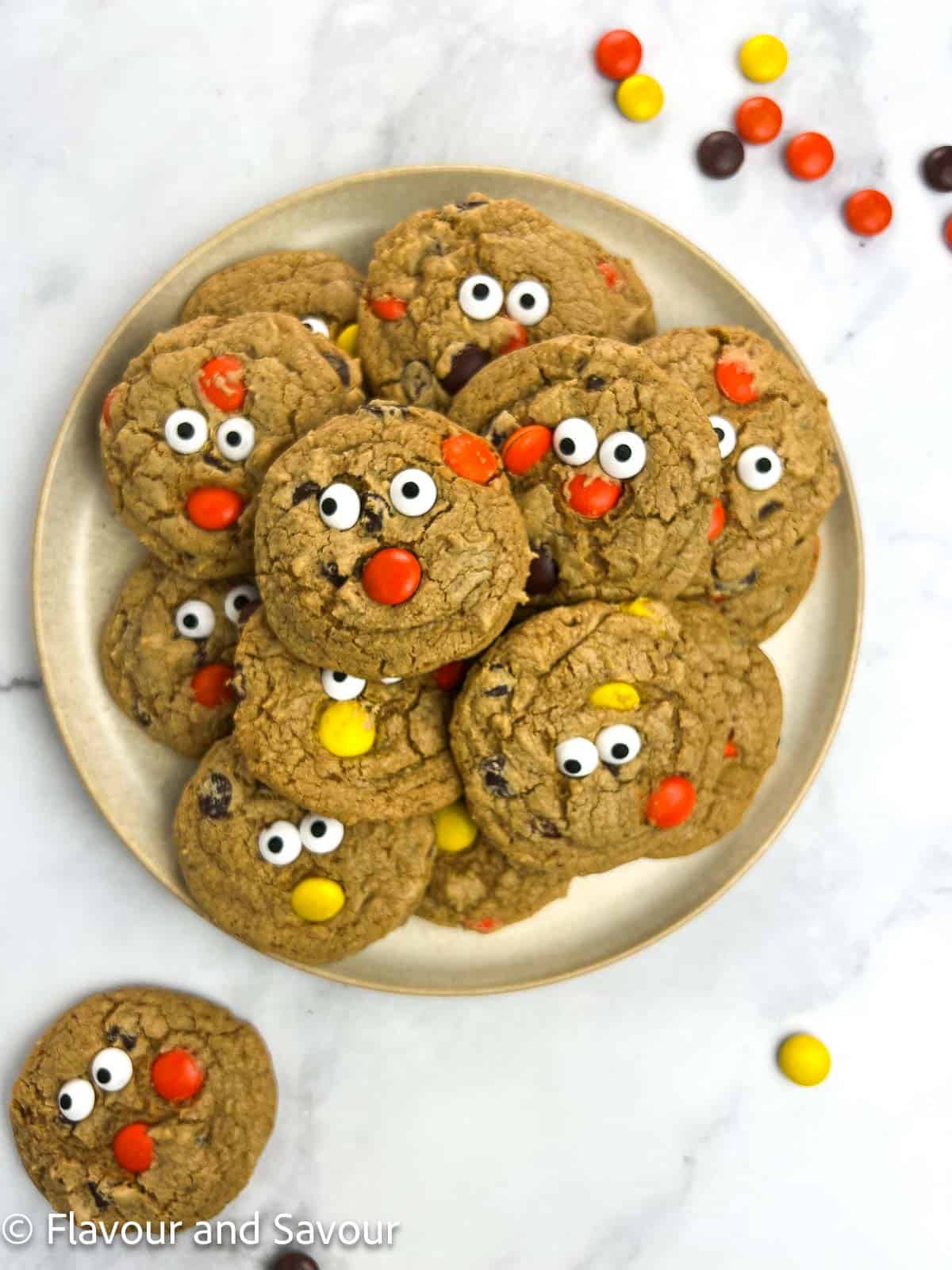 A plateful of gluten-free cookies with Reese's Pieces, chocolate chips and edible monster eyeballs for Halloween.