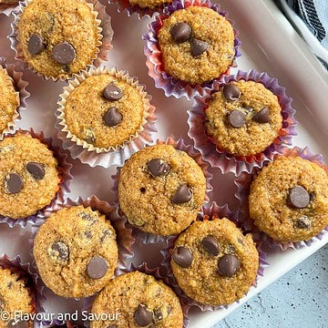 Square image of mini gluten-free pumpkin muffins with chocolate chips.