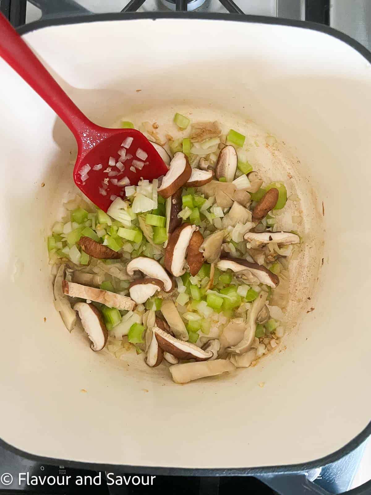 Sautéed vegetables and mushrooms in a pot for miso noodle soup.