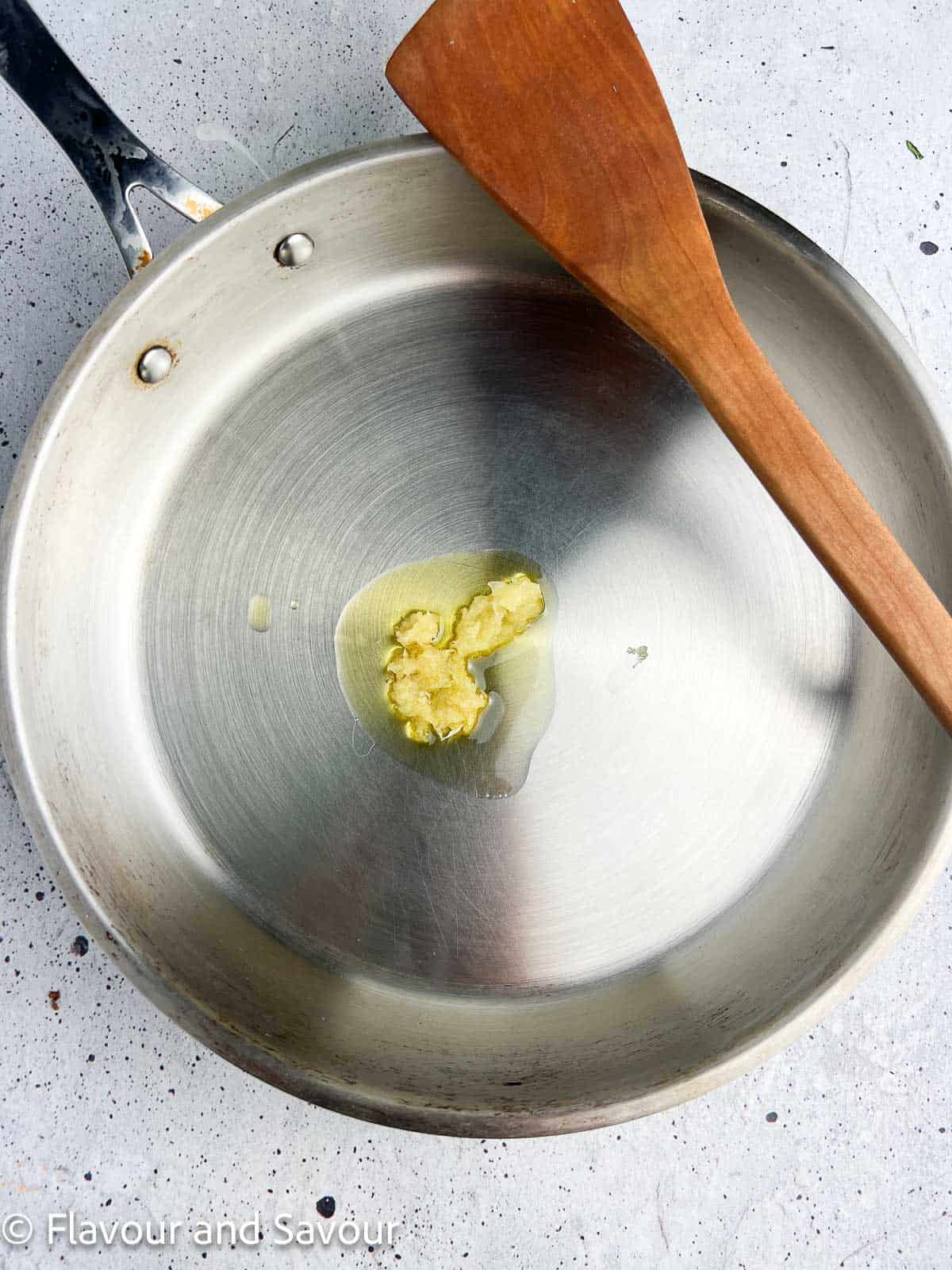 Minced garlic in oil in a skillet.