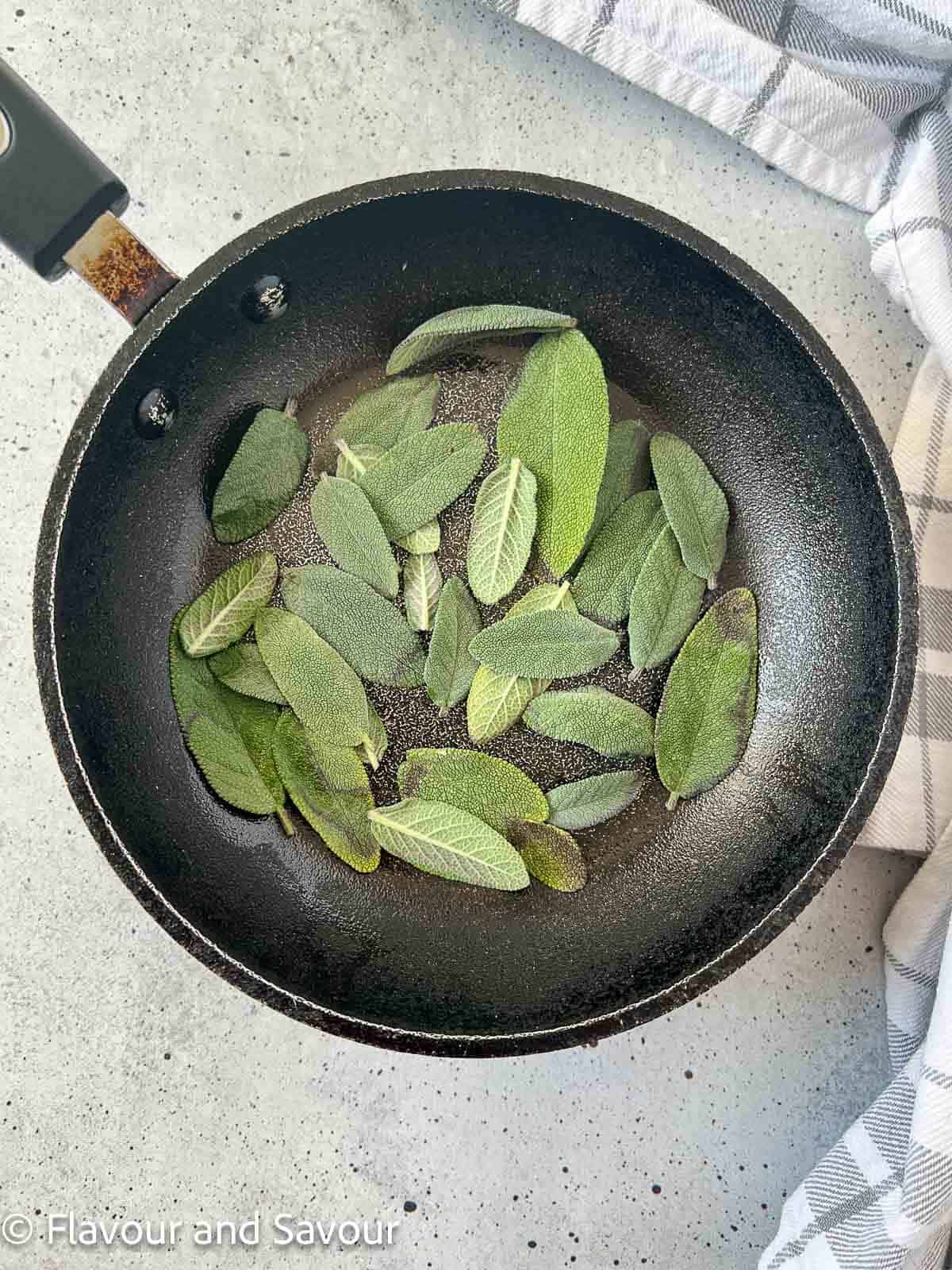 Sage leaves in a skillet.