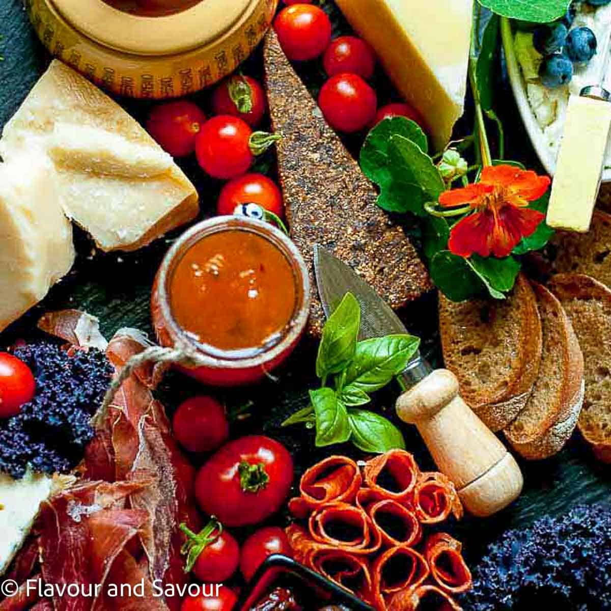 An Italian style antipasto platter with a variety of cured meats, cheese, dips and vegetables.