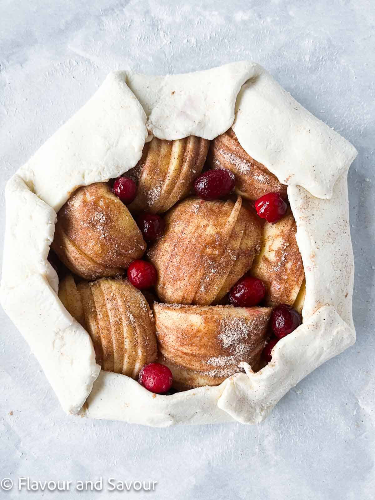Puff pastry folded over sliced apples to make a galette.