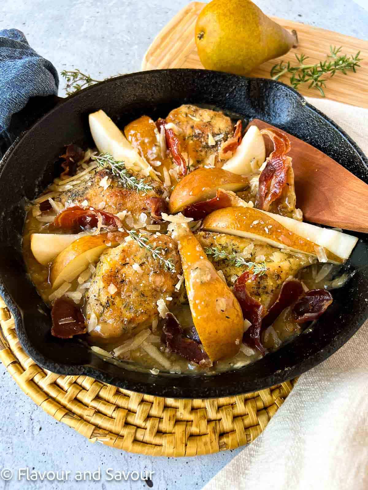 Baked chicken breasts with sliced Bosc pears, small pieces of crisp prosciutto ham, topped with grated Parmigiano Reggiano cheese.