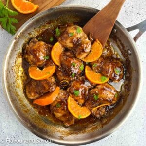 Hoisin orange chicken thighs in a skillet.