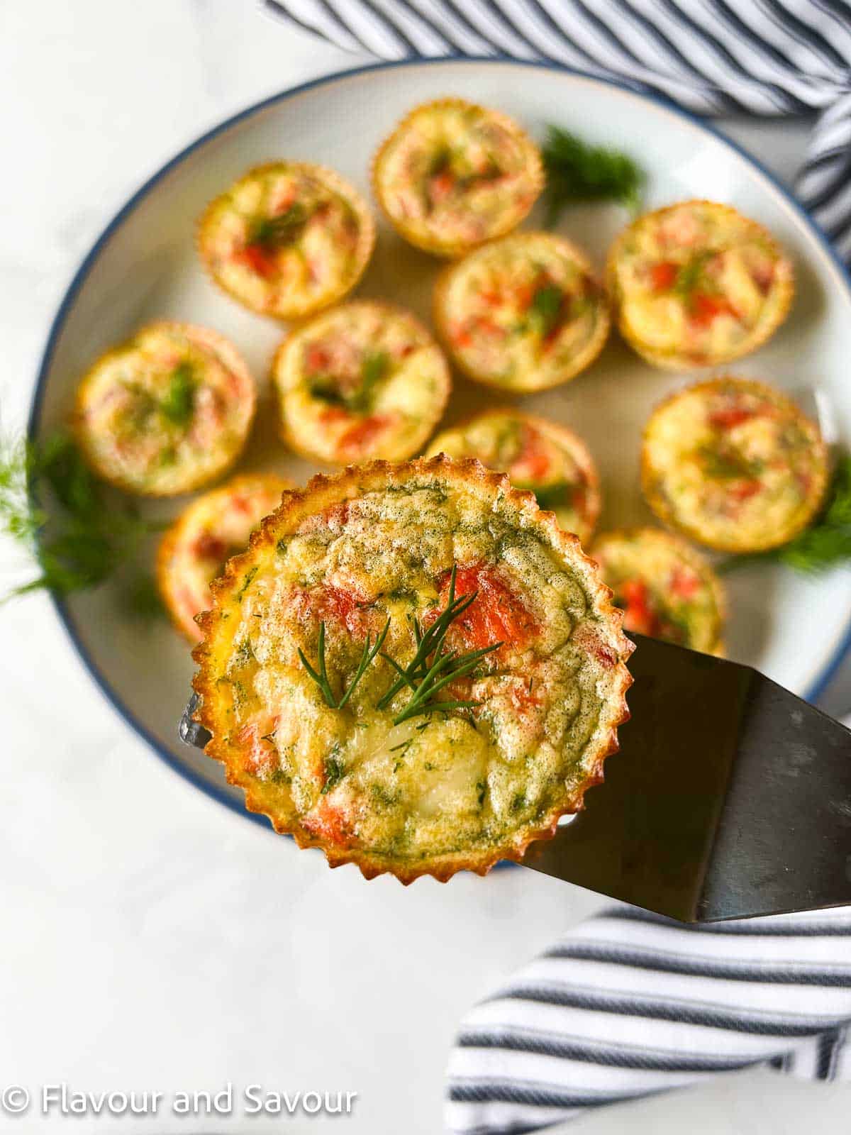 One mini smoked salmon quiche on a lifter.