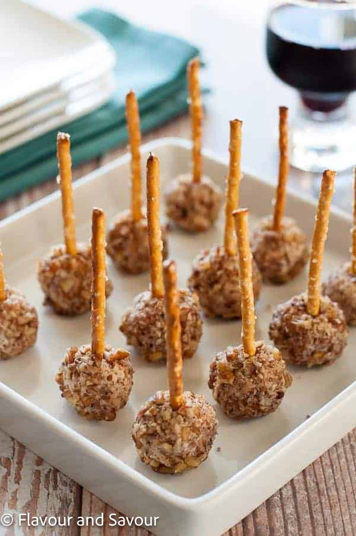 Mini goat cheese balls with pretzel sticks.
