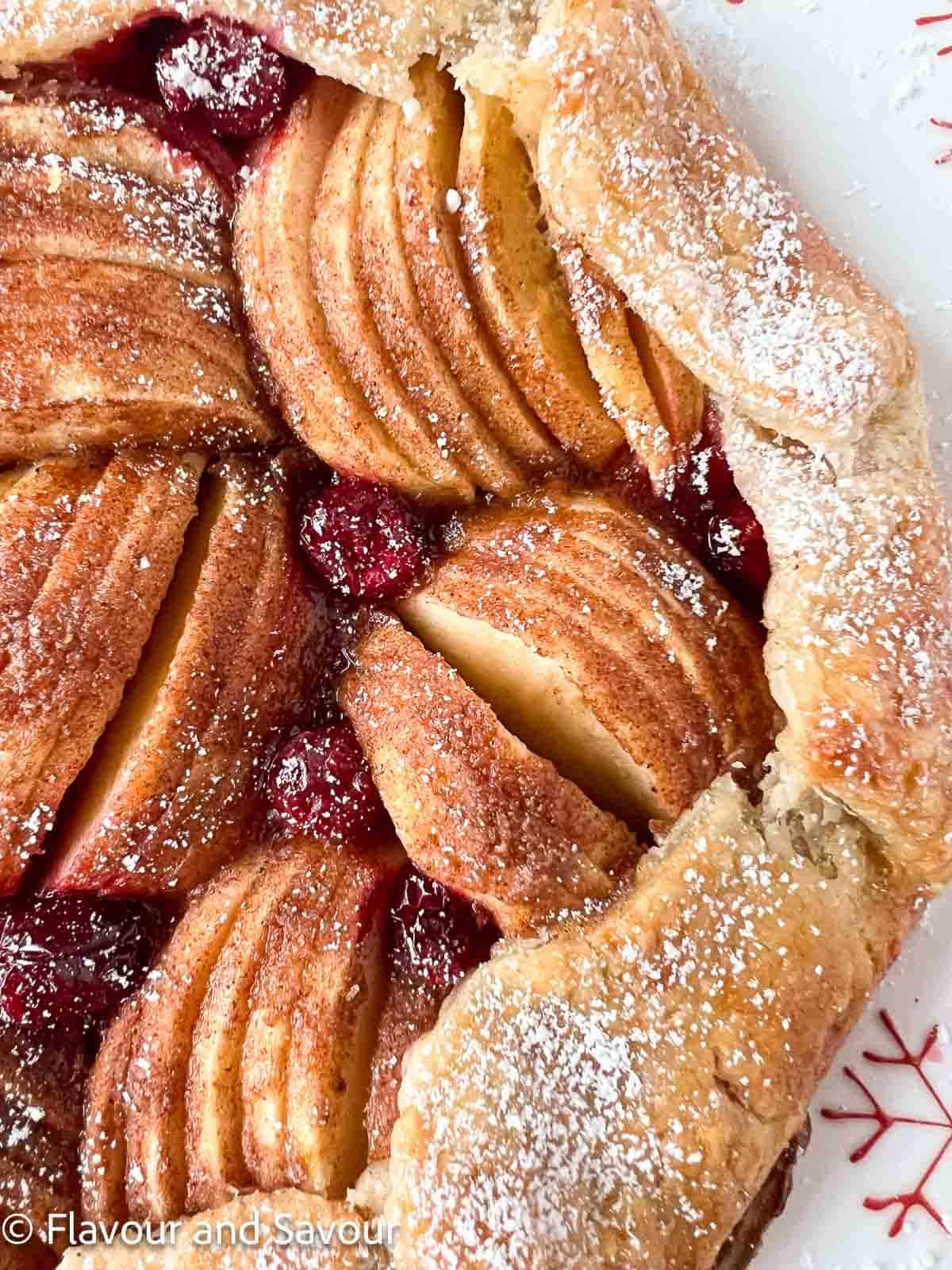 Puff pastry apple galette with cranberries, showing groups of thinly sliced apples.