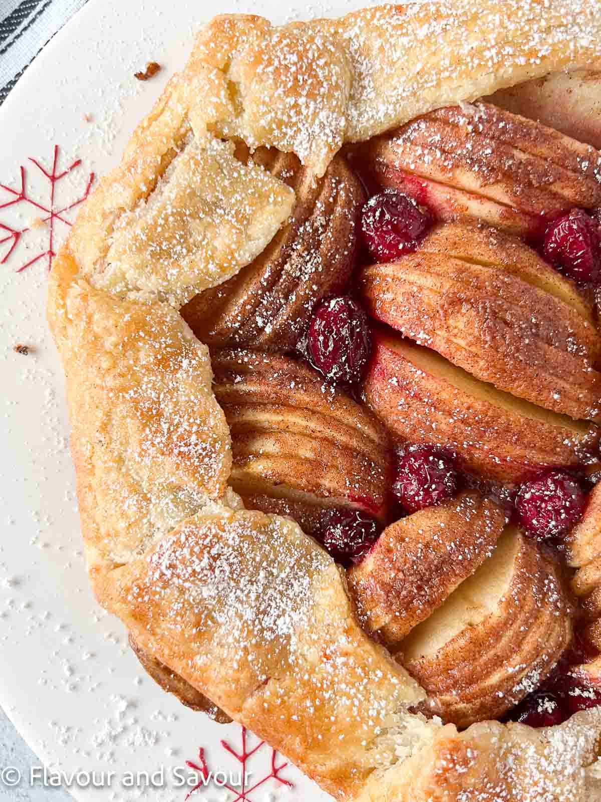 Puff pastry apple cranberry galette sprinkled with confectioner's sugar.