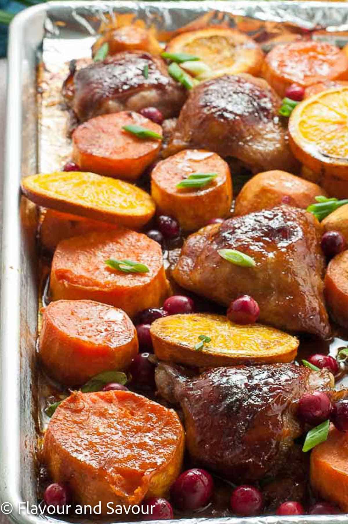 A sheet pan meal of hoisin chicken, sweet potatoes, oranges and cranberries.