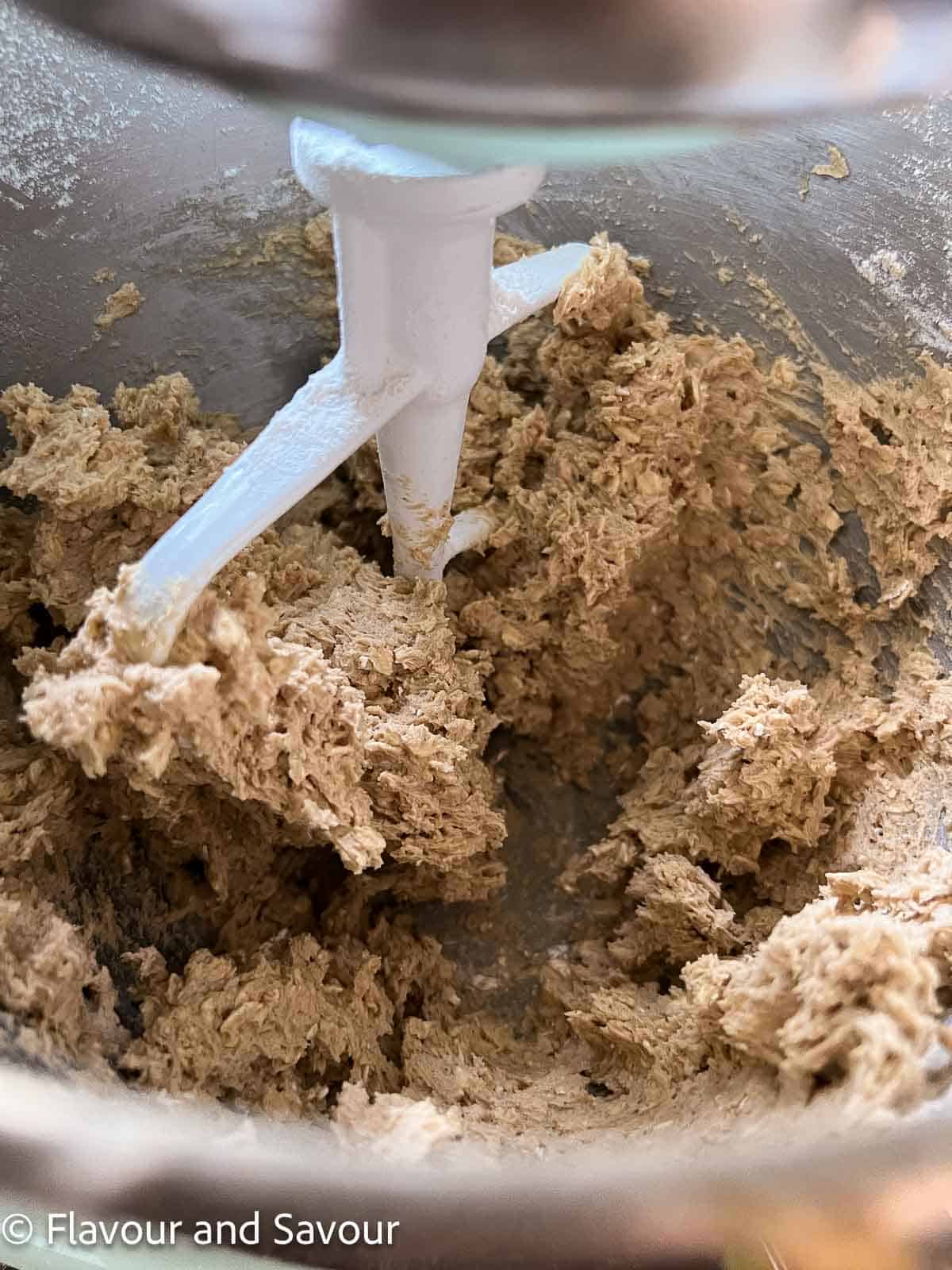 Oatmeal cookie dough in a stand mixer.