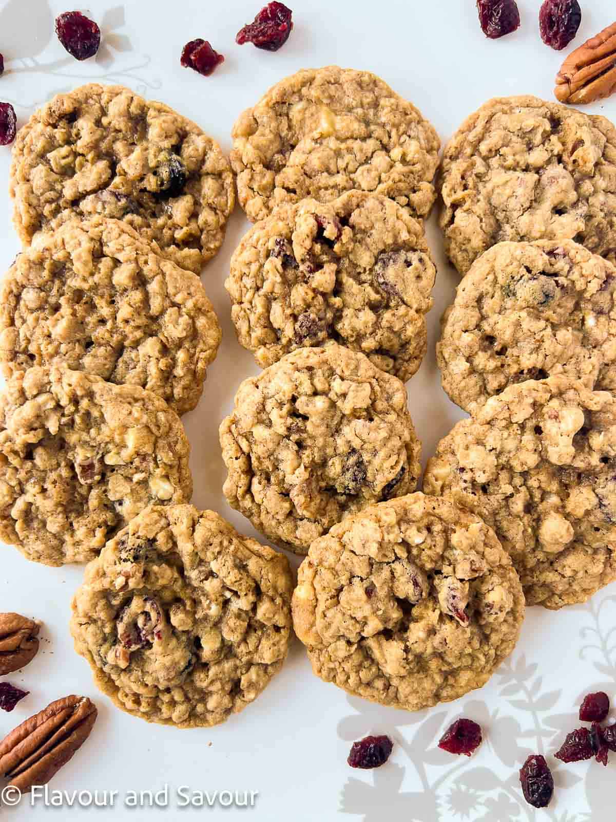 Gluten-free cranberry pecan white chocolate oatmeal cookies in rows on a serving plate.
