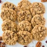 Cranberry pistachio oatmeal cookies with white chocolate in rows on a serving plate.