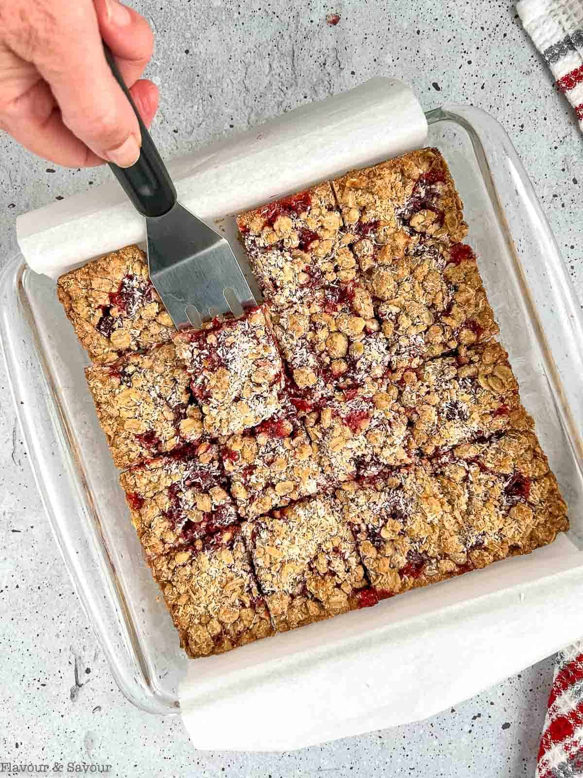 A baking pan with sliced Cranberry Lemon Oat Bars.