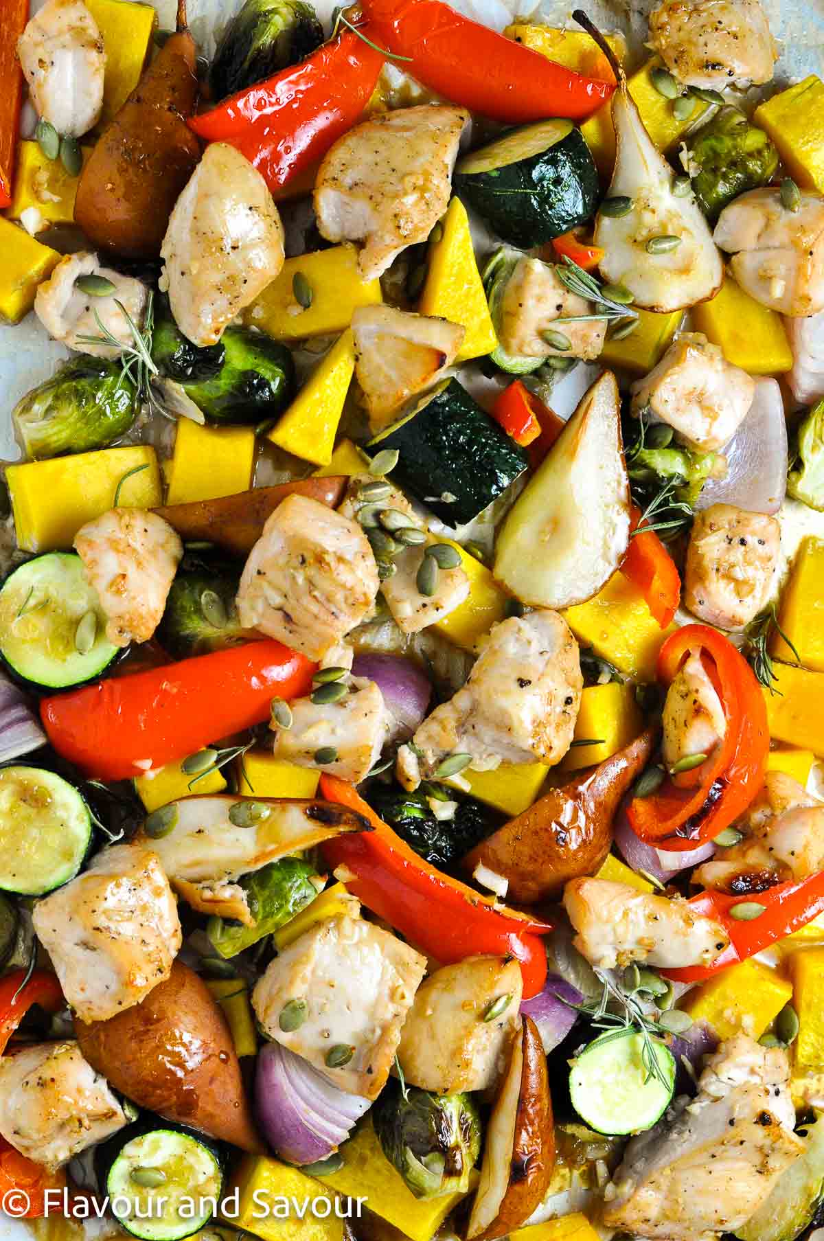 Maple Garlic Chicken Sheet Pan Dinner with seasonal vegetables and roasted pears.