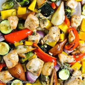 A sheet pan dinner with chicken cubes and seasonal vegetables.