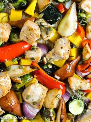 A sheet pan dinner with chicken cubes and seasonal vegetables.