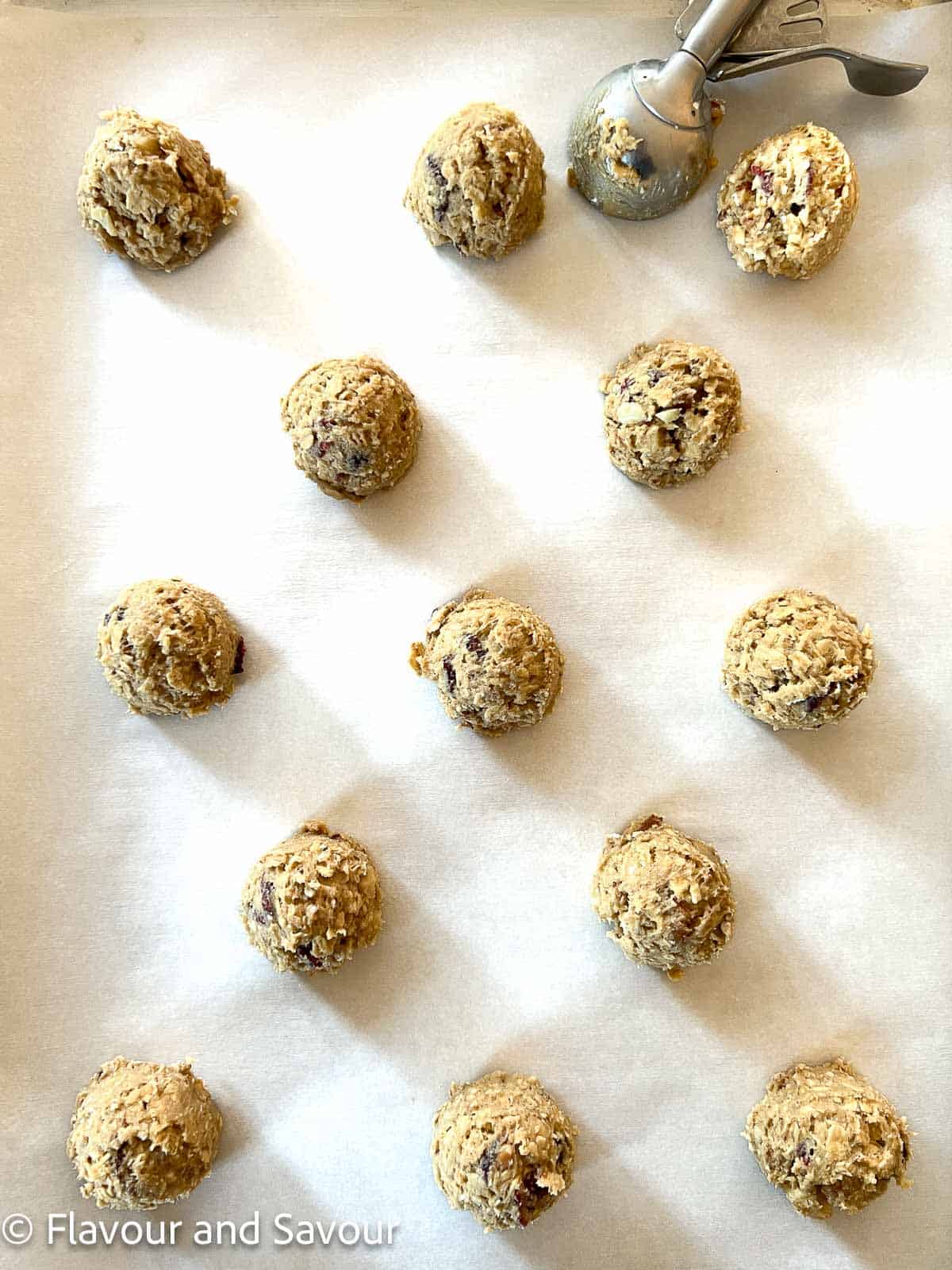 Oatmeal cookie dough balls on a baking sheet.
