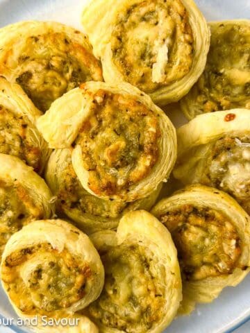 Puff pastry pesto pinwheels on a plate.