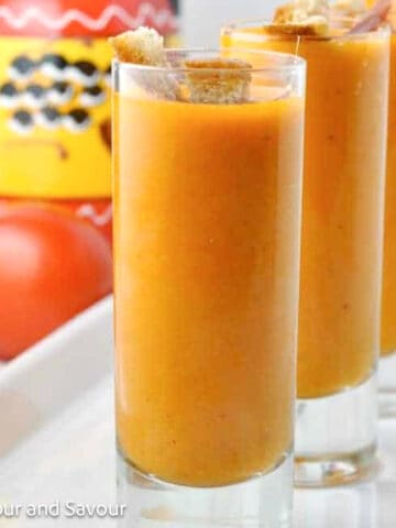 Shot glasses filled with Salmorejo, Spanish chilled tomato soup.