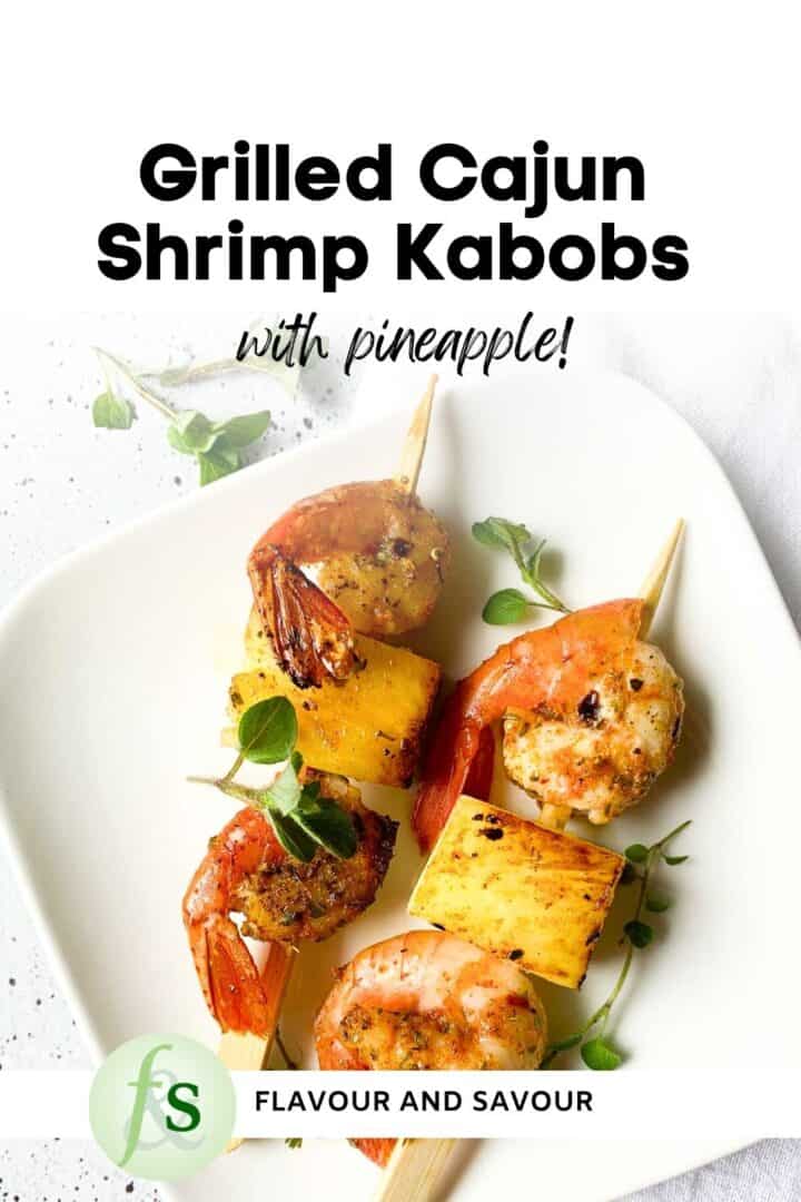 Image with text overlay for grilled Cajun shrimp kabobs with pineapple.