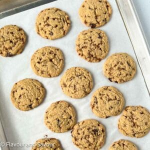 Toffee chocolate chip cookies on a baking sheet.