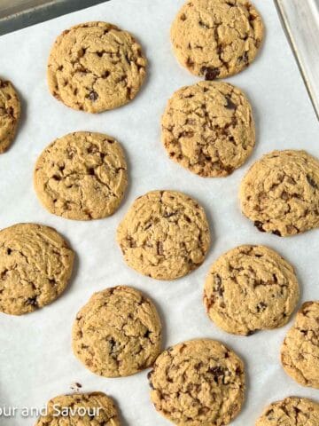 Toffee chocolate chip cookies on a baking sheet.