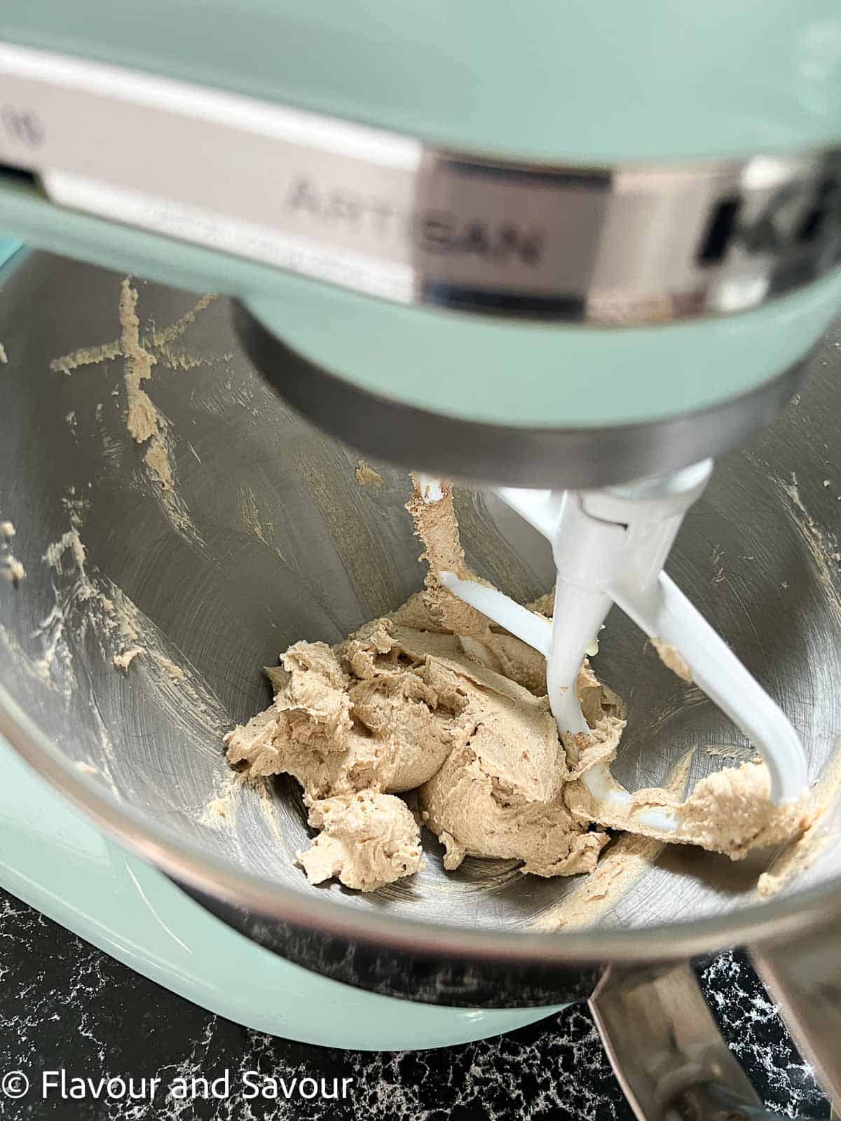 Creamed butter and sugar for toffee chocolate chip cookie batter in a stand mixer.