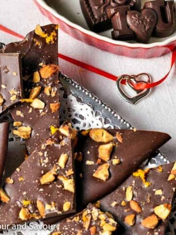 Orange and almond chocolate bark on a silver tray.