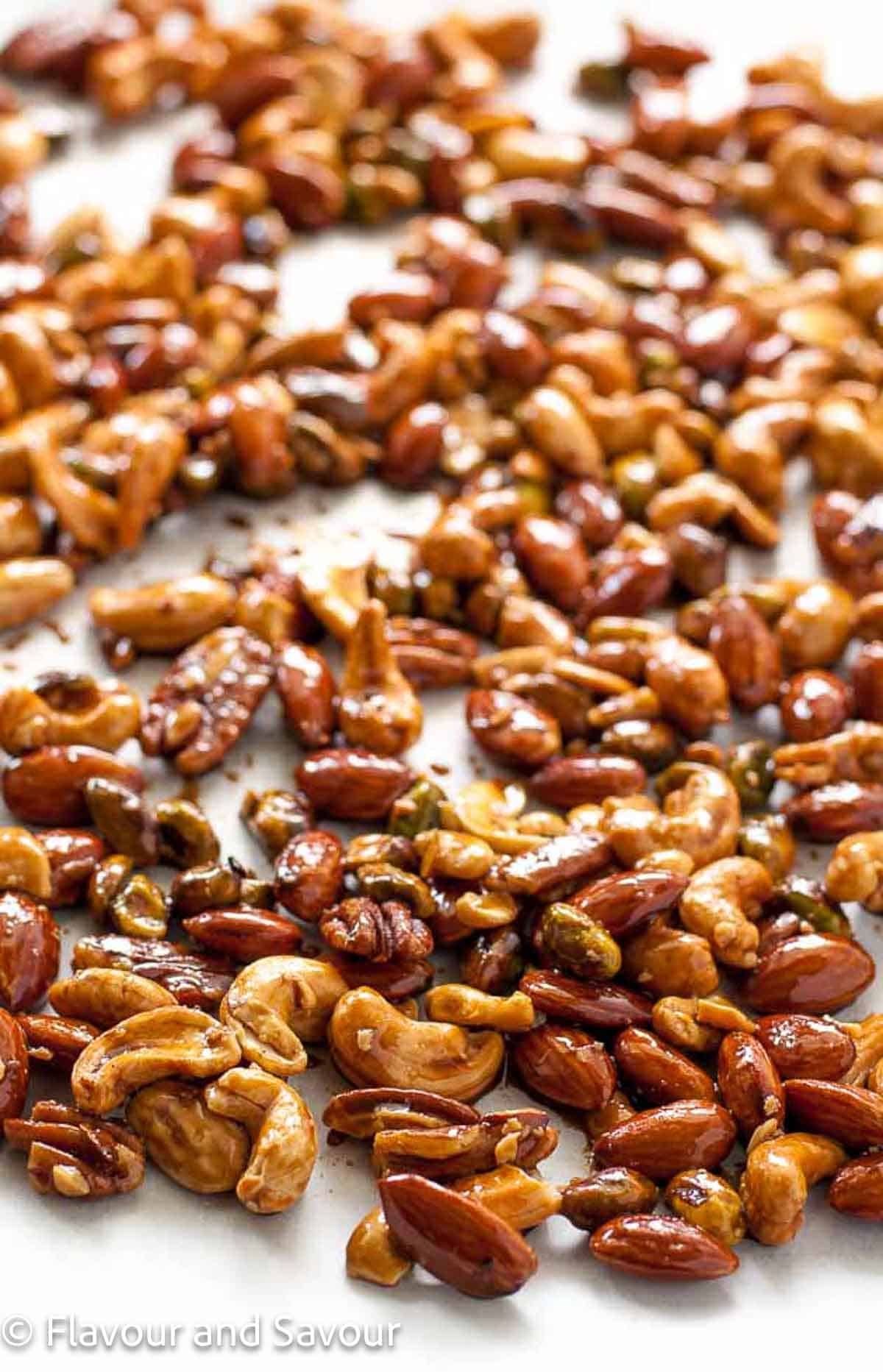 Espresso glazed nut mix on a baking sheet.