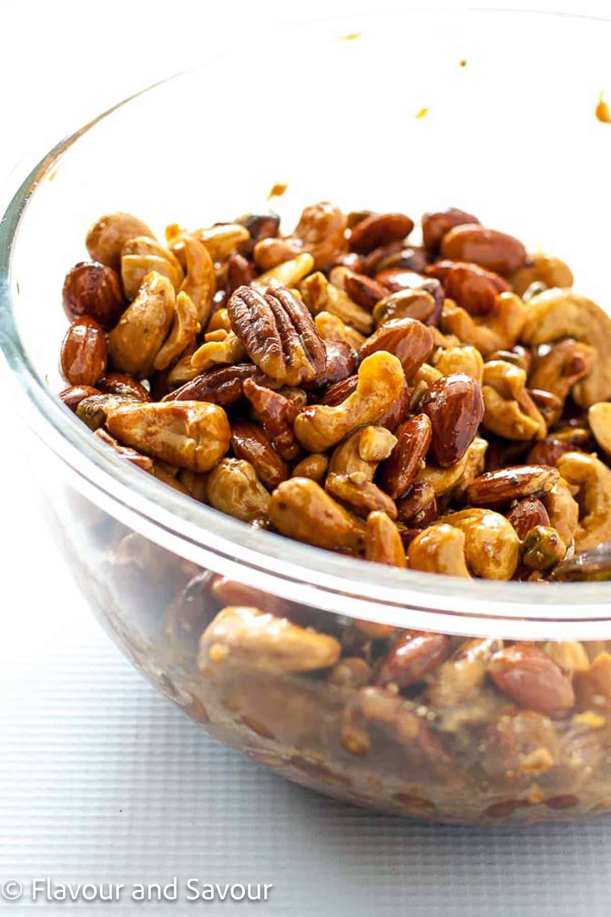 Espresso glazed holiday party nut mix in a glass bowl.