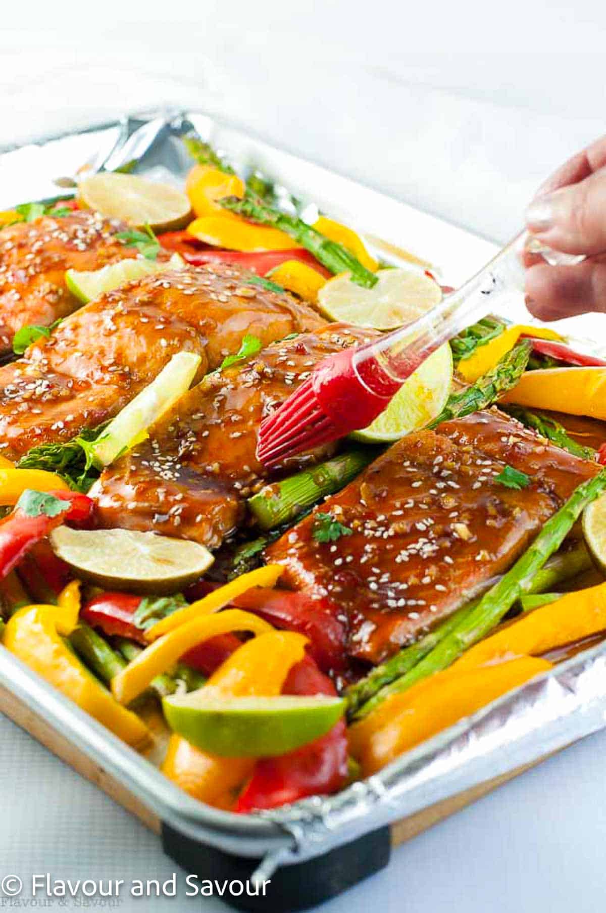 Brushing Thai chili glaze on salmon fillets.