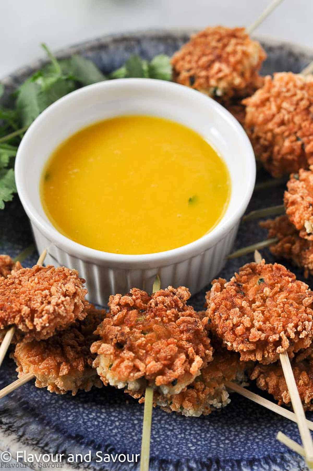 Thai shrimp fritters with a bowl of mango dipping sauce.