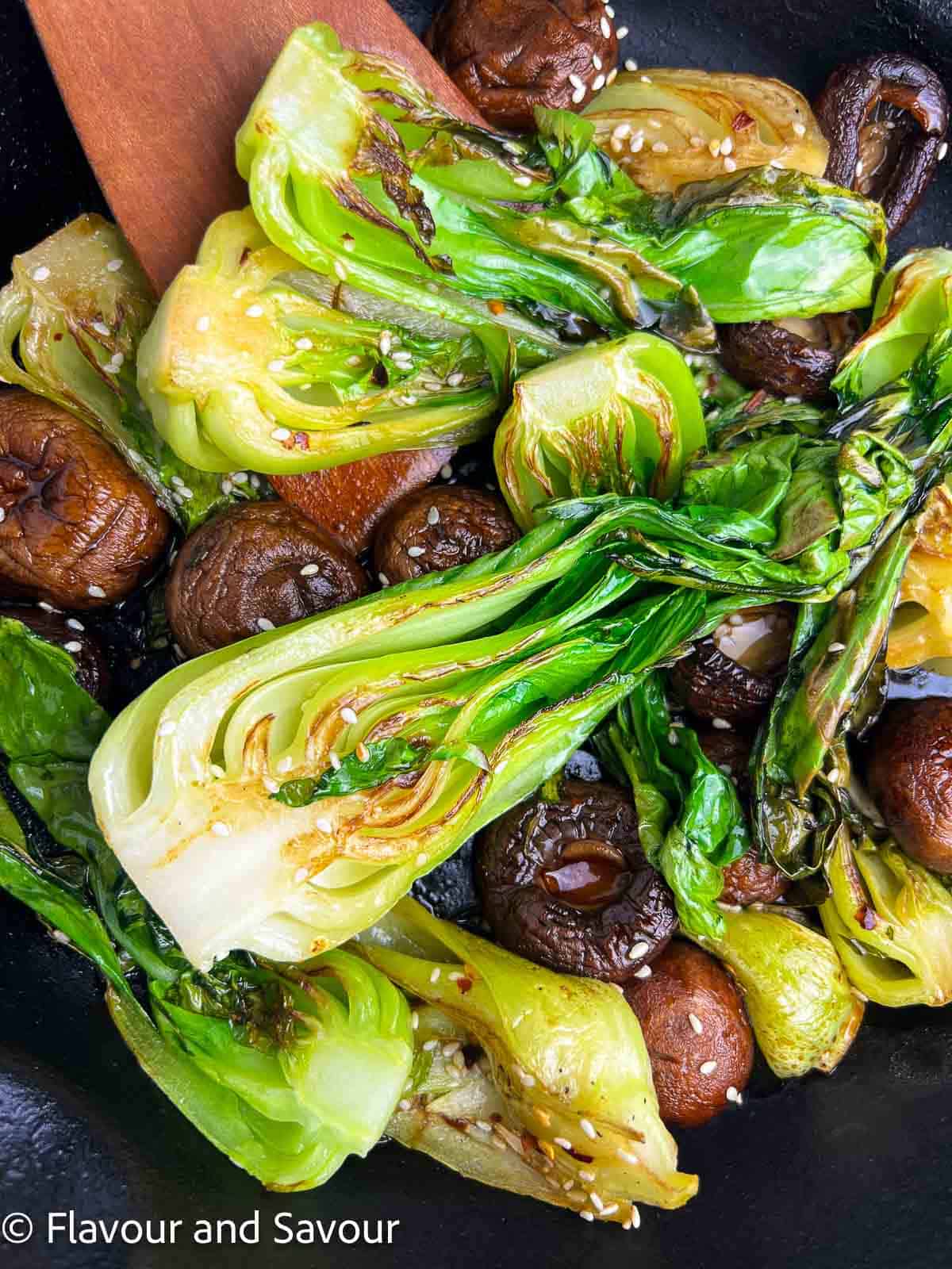 Bok choy and mushrooms stir fried and sprinkled with sesame seeds.