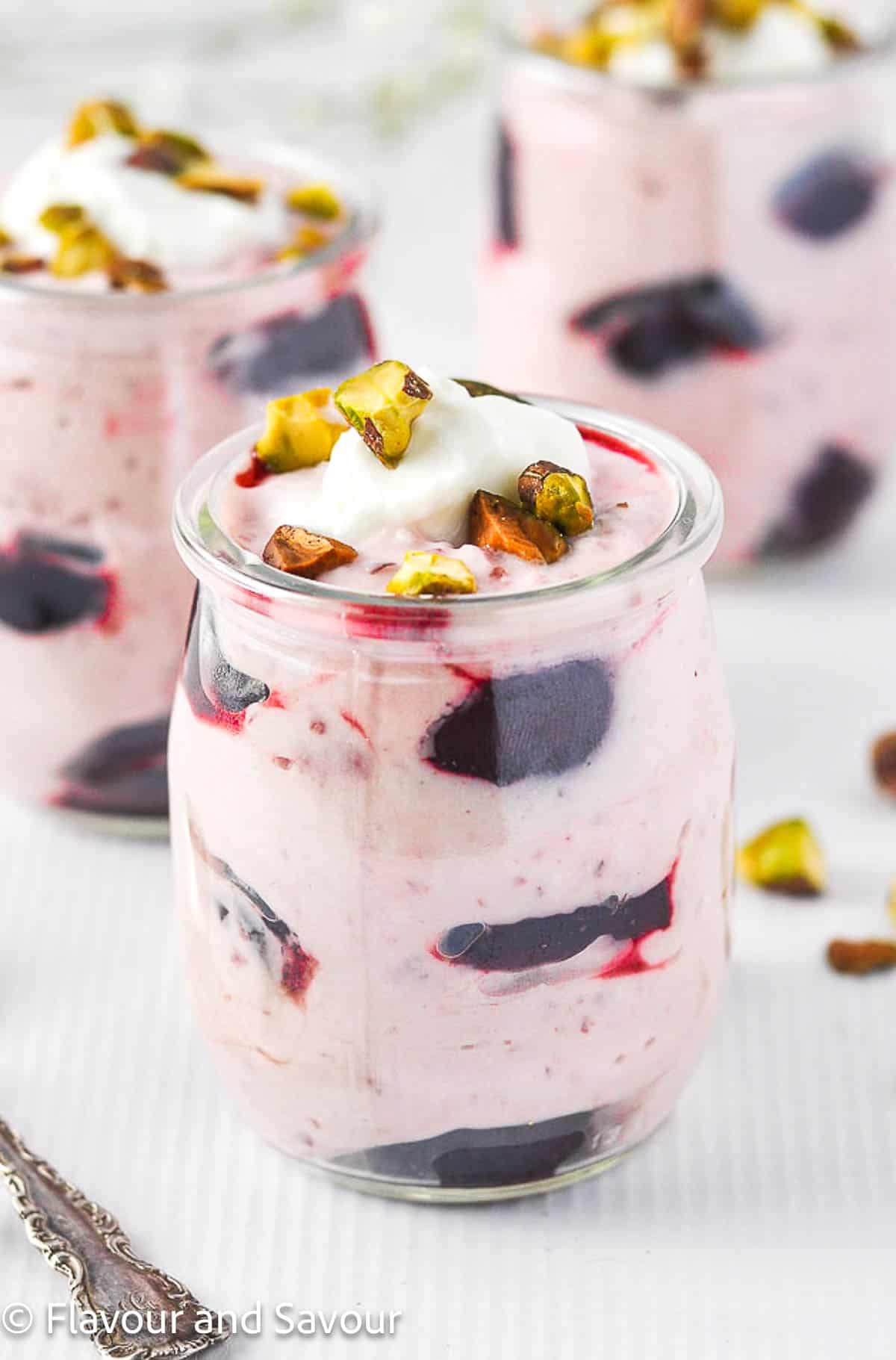 Cherry fool dessert made with Greek yogurt and cherries in a small dessert glass.